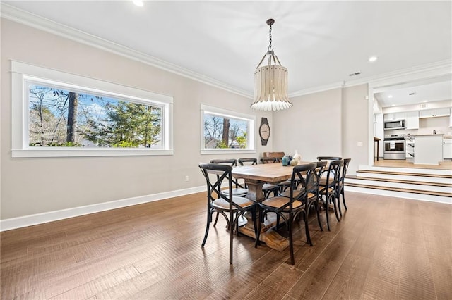 dining room featuring dark hardwood / wood-style flooring and ornamental molding