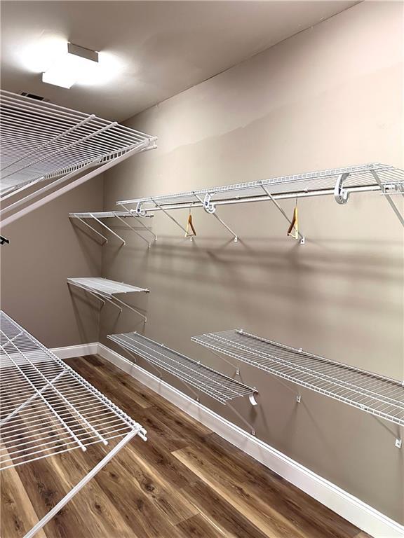 225 Austin Oaks Dr SE, Ellenwood, GA 30294 - walk in closet featuring wood finished floors