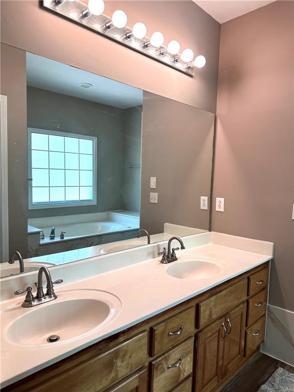 225 Austin Oaks Dr SE, Ellenwood, GA 30294 - full bath with a bath, double vanity, and a sink
