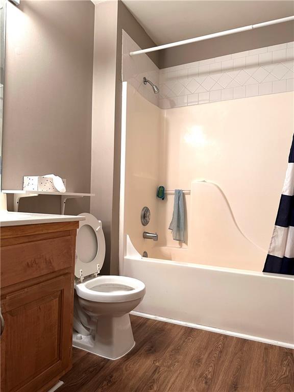 225 Austin Oaks Dr SE, Ellenwood, GA 30294 - bathroom with vanity, shower / bath combination with curtain, toilet, and wood finished floors