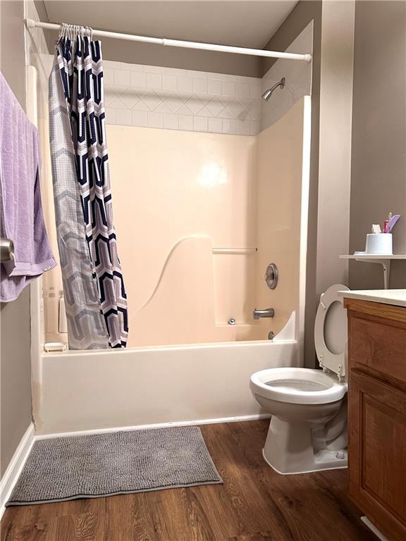 225 Austin Oaks Dr SE, Ellenwood, GA 30294 - bathroom with shower / tub combo, vanity, toilet, and wood finished floors