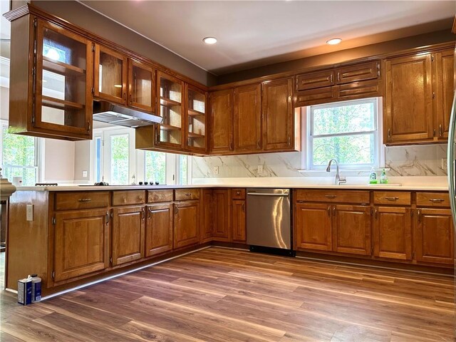 225 Austin Oaks Dr SE, Ellenwood, GA 30294 - kitchen with brown cabinets, under cabinet range hood, wood finished floors, and a healthy amount of sunlight
