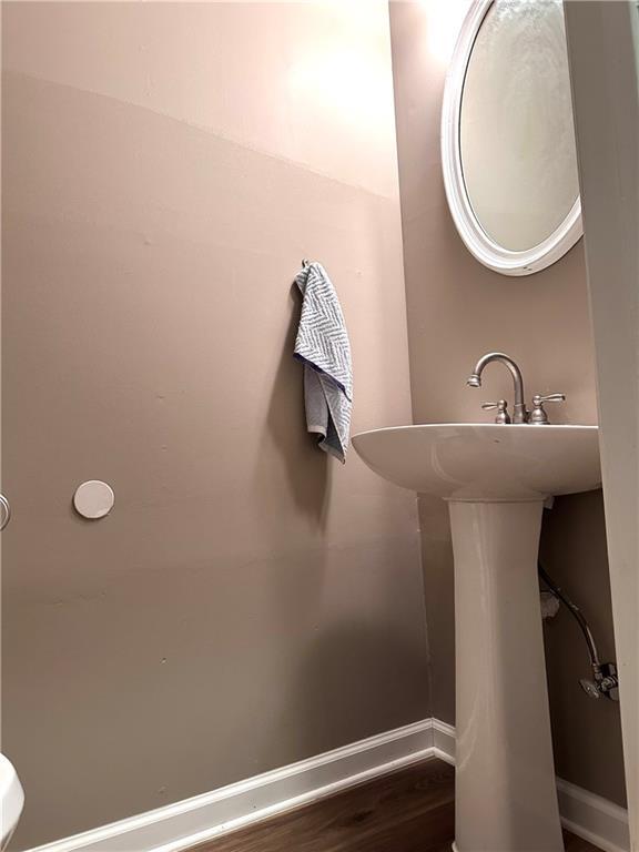 225 Austin Oaks Dr SE, Ellenwood, GA 30294 - bathroom with wood finished floors and baseboards