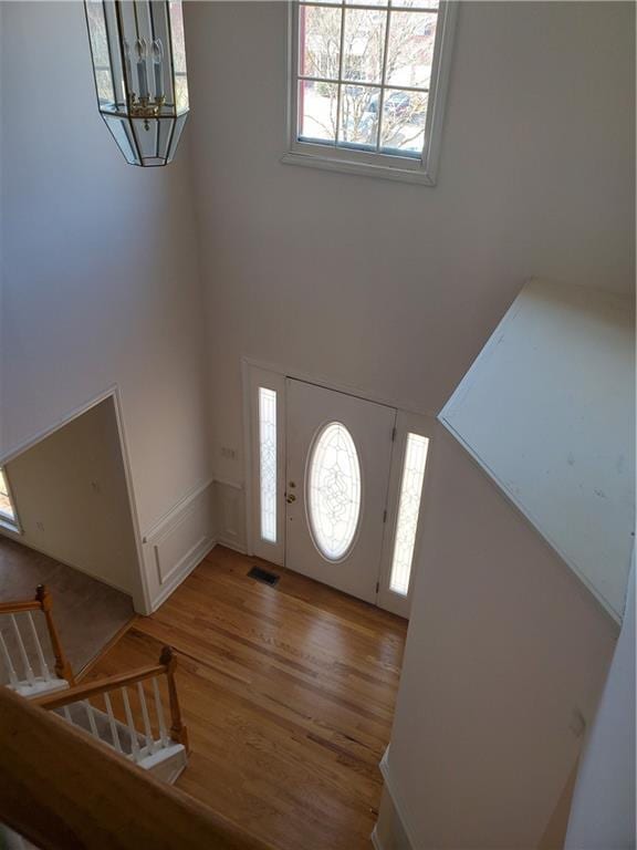 4217 Mill Grove Ln SW, Smyrna, GA 30082 - entrance foyer with light wood finished floors, a chandelier, and a high ceiling