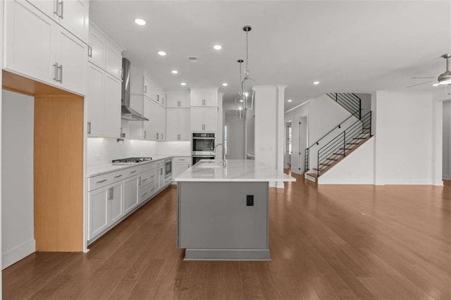 2023 Fern Mountain Ln, Marietta, GA 30064 - kitchen featuring recessed lighting, baseboards, wall chimney range hood, and open floor plan