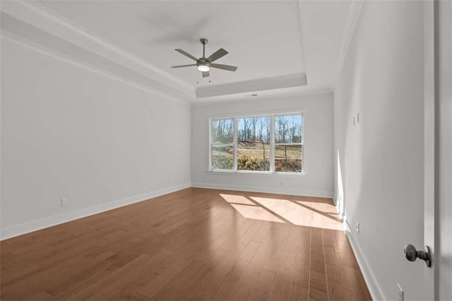 2023 Fern Mountain Ln, Marietta, GA 30064 - unfurnished room with a tray ceiling, wood finished floors, a ceiling fan, and baseboards
