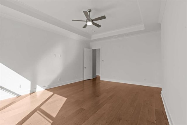 2023 Fern Mountain Ln, Marietta, GA 30064 - spare room featuring baseboards, a ceiling fan, wood finished floors, and a tray ceiling