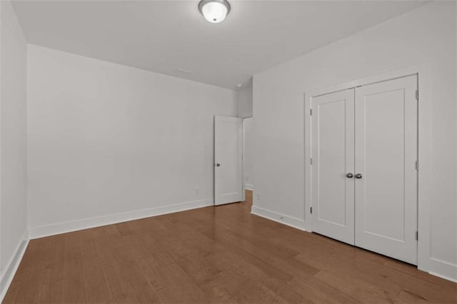 2023 Fern Mountain Ln, Marietta, GA 30064 - unfurnished bedroom featuring baseboards, wood finished floors, and a closet