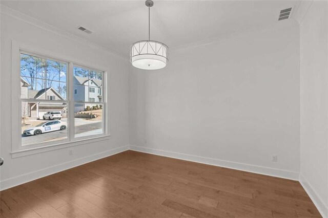 2023 Fern Mountain Ln, Marietta, GA 30064 - unfurnished dining area with visible vents, baseboards, wood finished floors, and ornamental molding