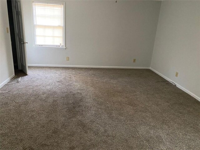 229 Smithstone Path, Fayetteville, GA 30214 - empty room with baseboards and dark carpet