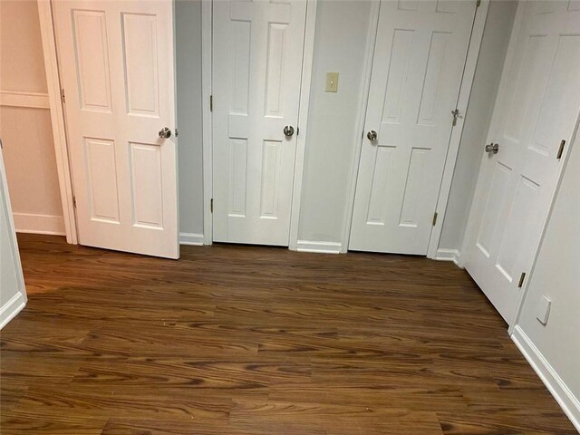 229 Smithstone Path, Fayetteville, GA 30214 - unfurnished bedroom with baseboards and dark wood-type flooring