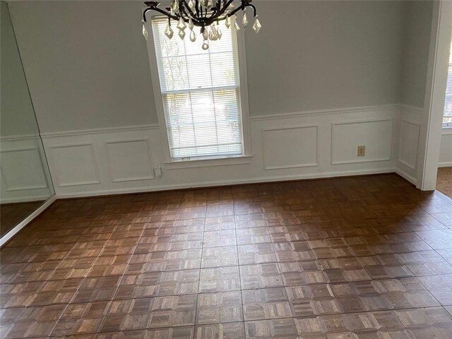 229 Smithstone Path, Fayetteville, GA 30214 - unfurnished dining area featuring a chandelier and a wainscoted wall