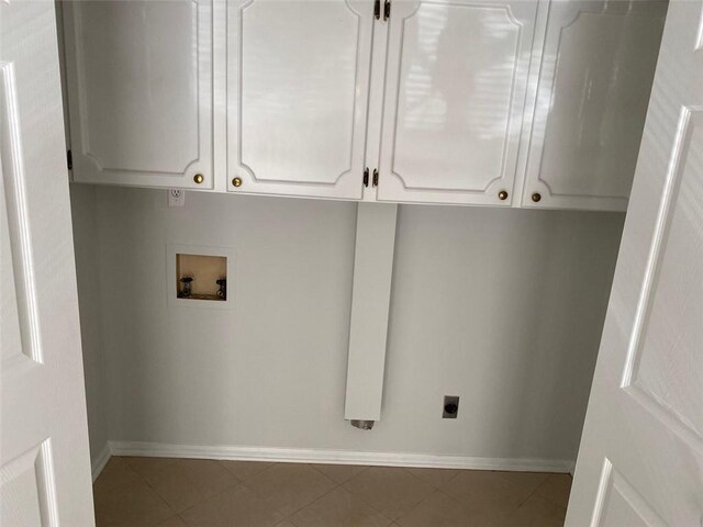 229 Smithstone Path, Fayetteville, GA 30214 - laundry area with light tile patterned floors, hookup for a washing machine, cabinet space, hookup for an electric dryer, and baseboards