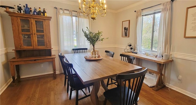 dining area featuring wood finished floors, baseboards, and ornamental molding