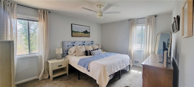 bedroom with carpet flooring, ceiling fan, visible vents, and baseboards