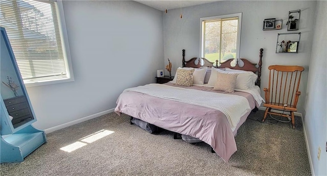 carpeted bedroom featuring multiple windows and baseboards