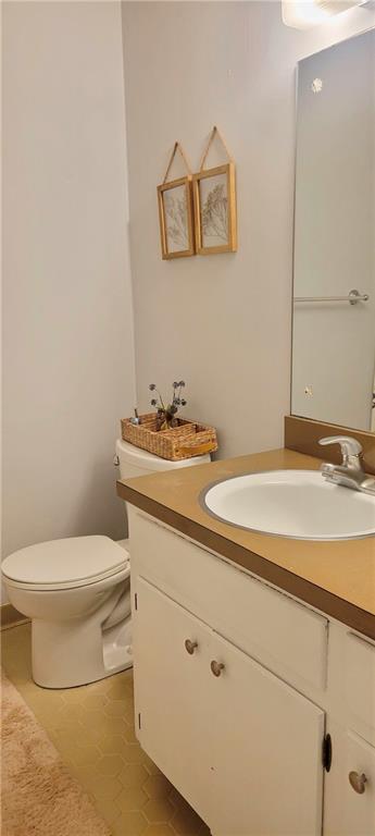 bathroom with tile patterned floors, toilet, and vanity