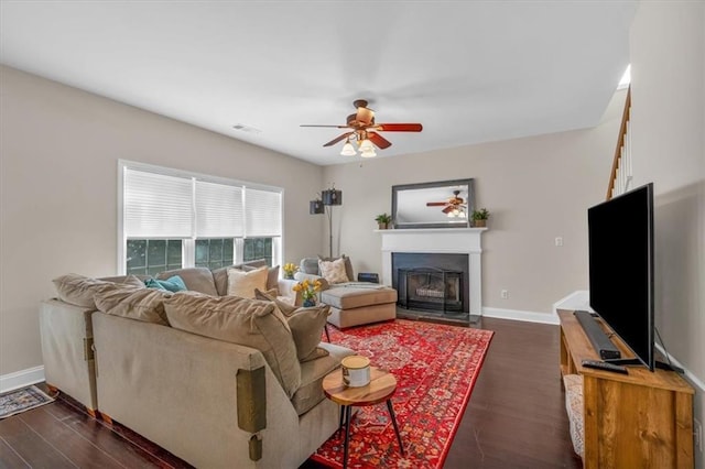 812 Roget Way, Lawrenceville, GA 30045 - living room featuring dark wood-style flooring, a ceiling fan, a fireplace with flush hearth, and baseboards
