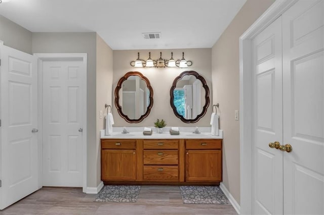 812 Roget Way, Lawrenceville, GA 30045 - full bathroom with double vanity, wood finished floors, and baseboards
