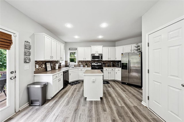 402 Homestead Dr, Dallas, GA 30157 - kitchen with stainless steel appliances, decorative backsplash, light countertops, light wood-style flooring, and recessed lighting