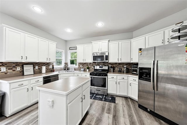 402 Homestead Dr, Dallas, GA 30157 - kitchen featuring stainless steel appliances, tasteful backsplash, a center island, white cabinets, and recessed lighting