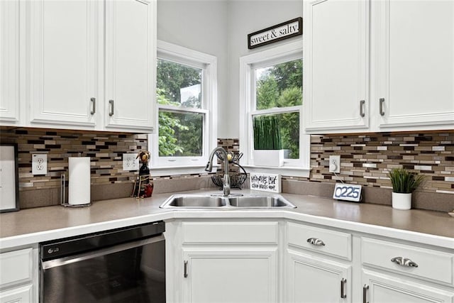 402 Homestead Dr, Dallas, GA 30157 - kitchen with dishwashing machine, white cabinets, backsplash, and light countertops