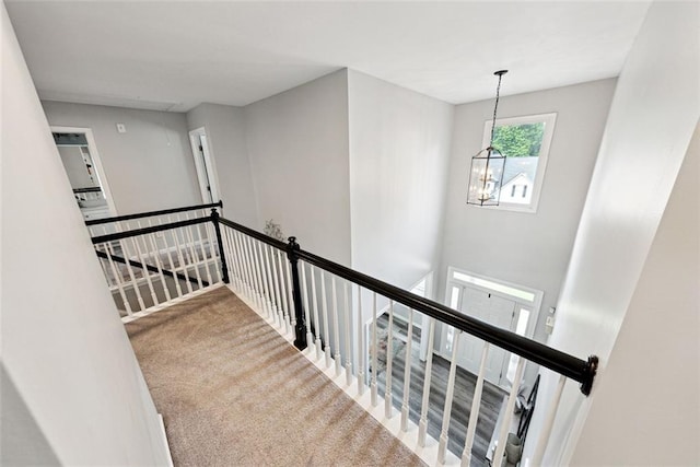 402 Homestead Dr, Dallas, GA 30157 - hall featuring an upstairs landing, carpet flooring, and a chandelier