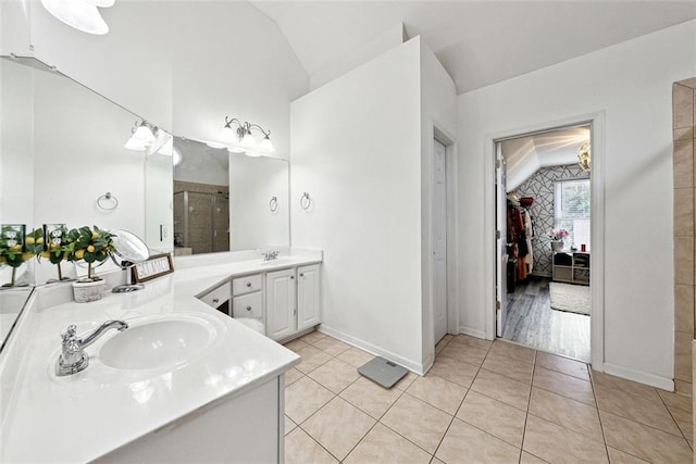 402 Homestead Dr, Dallas, GA 30157 - full bathroom featuring vaulted ceiling, double vanity, tile patterned floors, and a shower