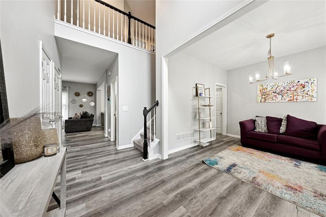 402 Homestead Dr, Dallas, GA 30157 - living room with wood finished floors, stairway, and a chandelier