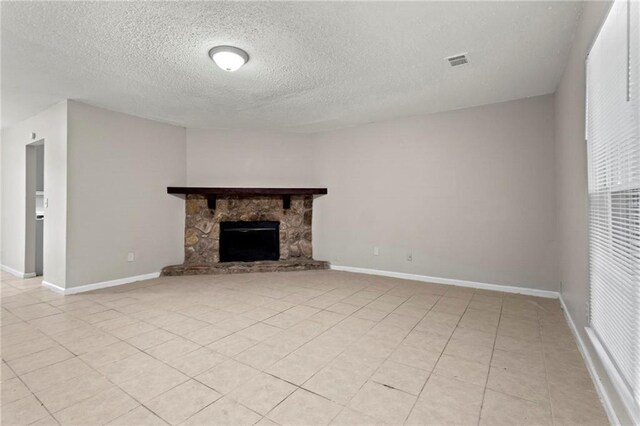 1056 Park W Ct, Stone Mountain, GA 30088 - unfurnished living room featuring a textured ceiling, light tile patterned flooring, baseboards, and a fireplace