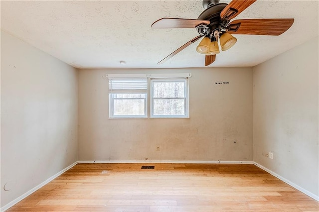 empty room featuring ceiling fan and light hardwood / wood-style flooring