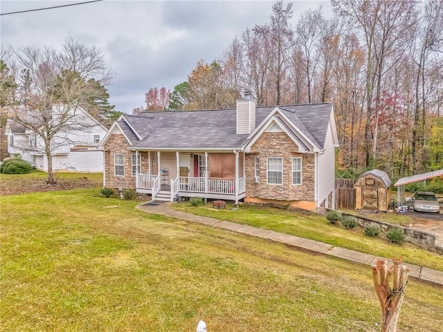 view of front facade with a storage unit, a porch, and a front yard