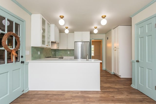 6795 Brandon Mill Rd, Atlanta, GA 30328 - kitchen with stainless steel fridge, glass insert cabinets, light countertops, and a peninsula