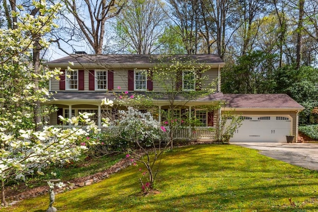 6795 Brandon Mill Rd, Atlanta, GA 30328 - view of front facade with concrete driveway, a garage, a front lawn, and covered porch