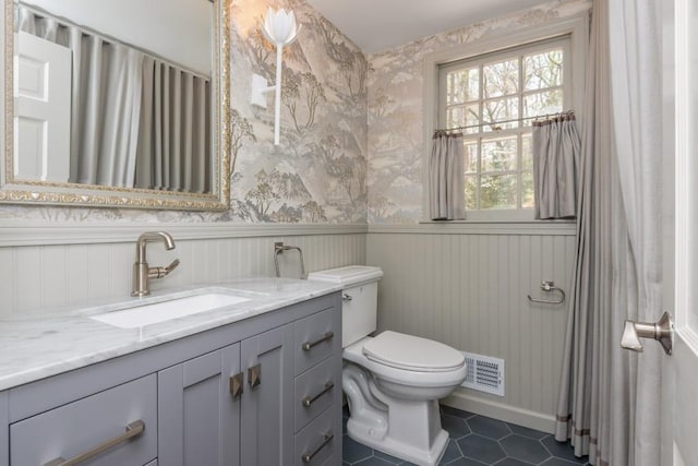 6795 Brandon Mill Rd, Atlanta, GA 30328 - bathroom with a wainscoted wall, tile patterned flooring, vanity, toilet, and wallpapered walls