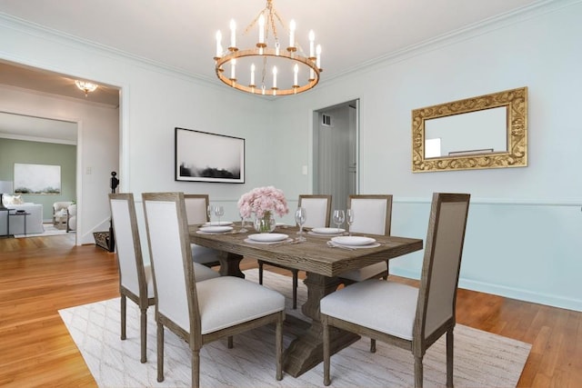6795 Brandon Mill Rd, Atlanta, GA 30328 - dining room featuring ornamental molding, light wood finished floors, a chandelier, and baseboards