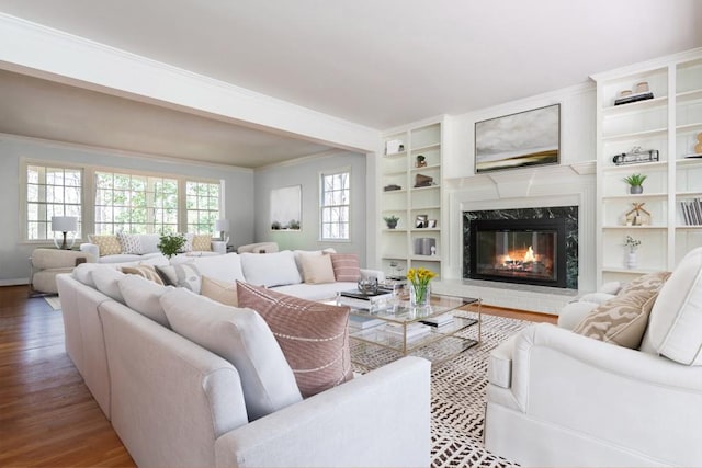 6795 Brandon Mill Rd, Atlanta, GA 30328 - living area featuring wood finished floors, a high end fireplace, crown molding, built in features, and baseboards