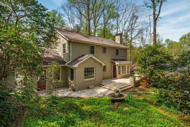 6795 Brandon Mill Rd, Atlanta, GA 30328 - back of property with a chimney, a patio, a deck, and roof with shingles