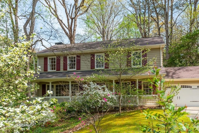 6795 Brandon Mill Rd, Atlanta, GA 30328 - view of front of property featuring a porch, a garage, concrete driveway, and a front lawn