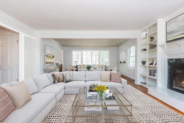 6795 Brandon Mill Rd, Atlanta, GA 30328 - living area with crown molding, a fireplace, wood finished floors, baseboards, and built in shelves
