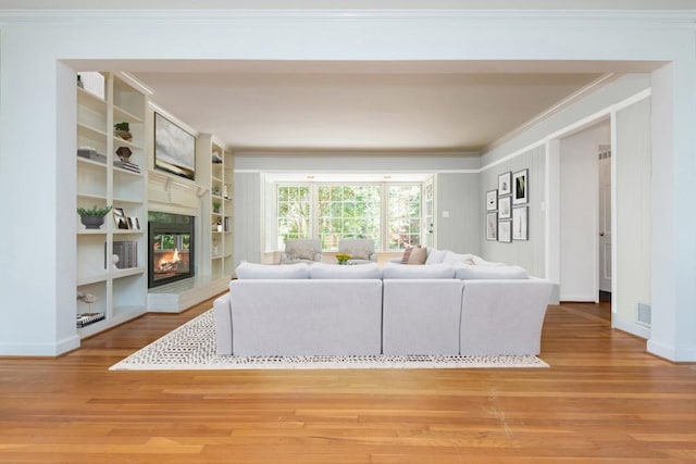 6795 Brandon Mill Rd, Atlanta, GA 30328 - living area with crown molding, wood finished floors, a multi sided fireplace, and baseboards