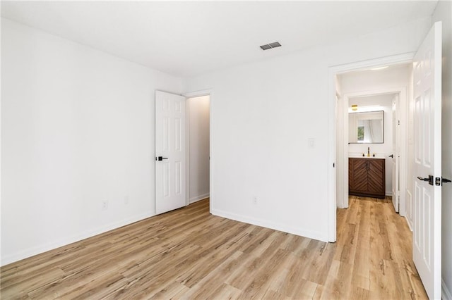 unfurnished bedroom featuring light wood-type flooring