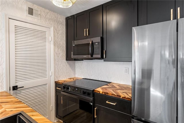 kitchen with stainless steel appliances and wooden counters