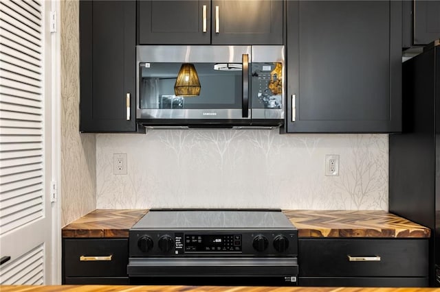 kitchen featuring black / electric stove, refrigerator, and tasteful backsplash