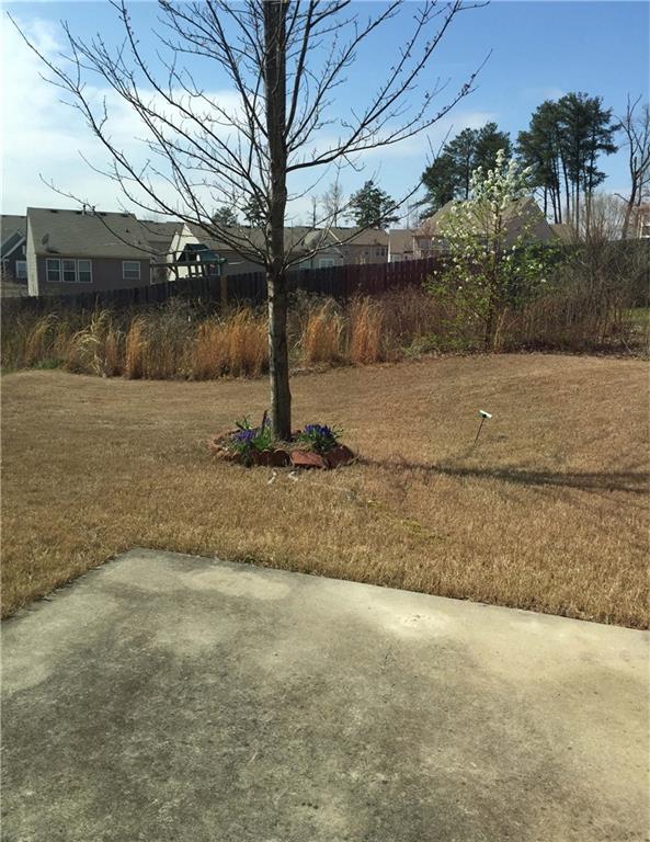 2955 Briaroak Dr, Duluth, GA 30096 - view of green lawn featuring a patio area