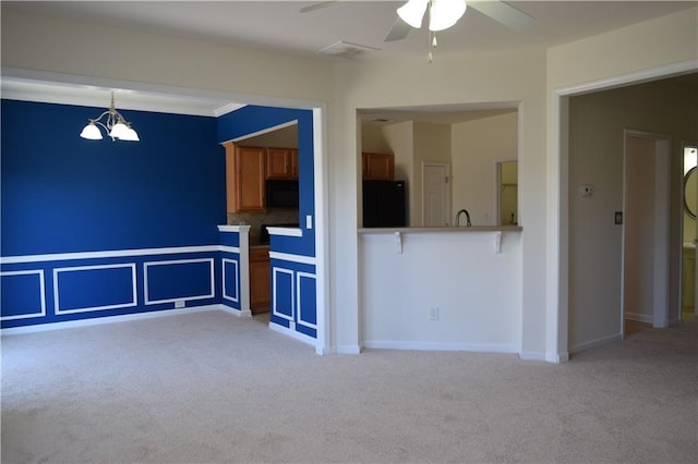 2955 Briaroak Dr, Duluth, GA 30096 - unfurnished living room with light colored carpet, a ceiling fan, and a chandelier