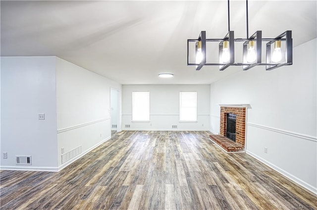 unfurnished living room featuring a fireplace and dark wood-type flooring