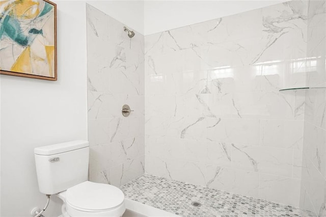 bathroom with toilet and tiled shower