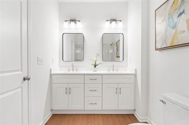 bathroom with vanity, hardwood / wood-style floors, and toilet