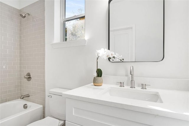 full bathroom featuring vanity, toilet, and tiled shower / bath